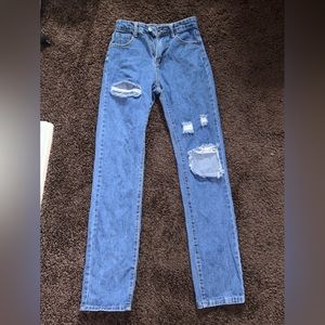 Distressed jeans, damage shown.